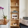 Bedroom with Resource Furniture Ulisse Wall Bed Desk, ply cabinetry by Mike Gagne, ceramics by Raquel Zimmermann (RZ), flowers by Beth Elliott and pillows by Oliver Yaphe.
